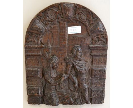 < A carved oak panel, 17th century, depicting the Flight to Egypt within an arched architectural border, 32cm by 25cm
