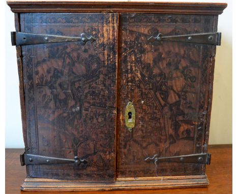 A pen work decorated table cabinet, late 17th century, of rectangular form with two doors enclosing a cupboard and an arrange