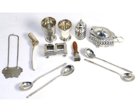 A 19th century Russian silver vodka tot, with engraved decoration of buildings; a set of four Russian silver teaspoons with b