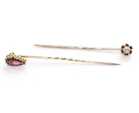 An old cut diamond stick pin, estimated diamond weight 0.20 and a garnet stick pin (2)The stickpins are in good condition. Th