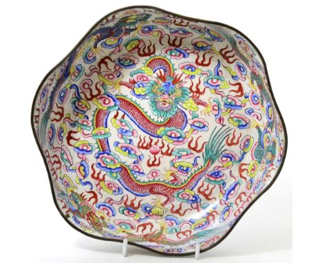 An Canton enamel bowl, Qing dynasty of hexafoil form, painted in famille rose enamels with dragons amongst cloud scrolls, the