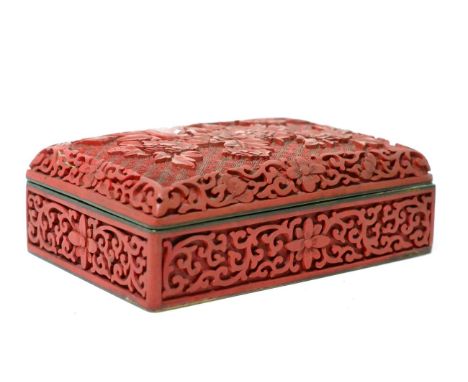 A Chinese cinnabar box and cover, 19th century, rectangular form carved with foliage amongst rock work, blue enamel interior,