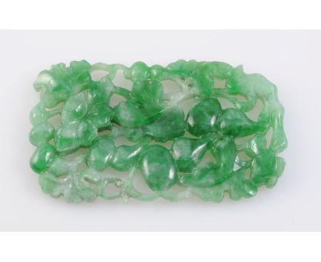 A JADE PLAQUE, the rectangular plaque carved elaborately in floral and foliage style. Length 5cm. Width 3cm. Weight 12.5gms. 