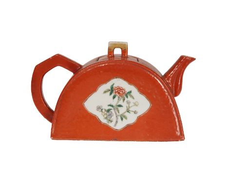 A CHINESE DEMILUNE TEAPOT, 19TH CENTURY, with red ground, painted with a floral spray within a shaped reserve to each side. 1