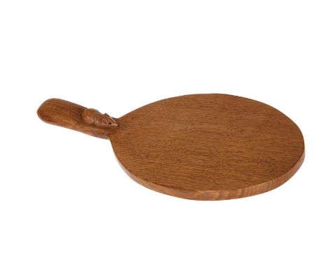 ROBERT THOMPSON OF KILBURNA MOUSEMAN OAK CHEESEBOARD, of characteristic form, with carved mouse signature. 37.5cm including h