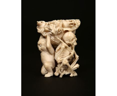 A JAPANESE IVORY OKIMONO, MEIJI PERIOD, carved with monkeys, toads and skeleton, one toad carved as a concealed stopper. 6.5c