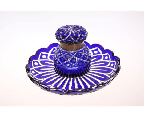 A CONTINENTAL BLUE AND CLEAR GLASS INKWELL, 19TH CENTURY, the circular base with scalloped edge. 18cm wide