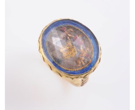 A 17TH CENTURY GLASS AND TAPESTRY SET RING, circa 1690-1700, the oval closed back mount engraved to the reverse with initials