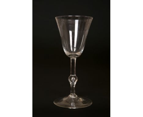 A LIGHT BALUSTER WINE GLASS, CIRCA 1740, with funnel bowl and ball knop containing a tear drop. 16.5cm