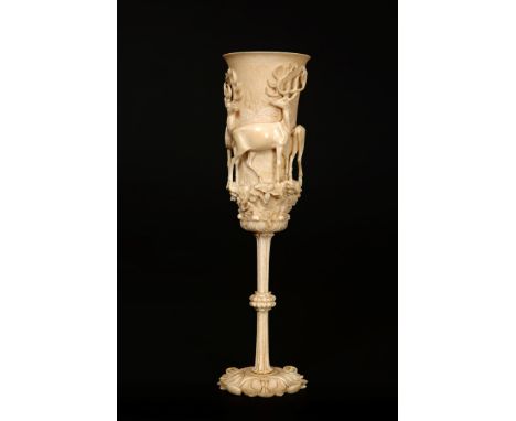 A EUROPEAN IVORY CUP, 19TH CENTURY, probably German or Austrian, the cup carved with two stags and a doe, the slender fluted 