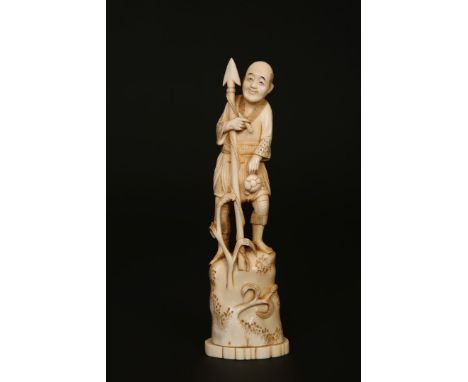 A JAPANESE MARINE IVORY OKIMONO, MEIJI PERIOD, carved as a fisherman holding a spear, signed. 23cm