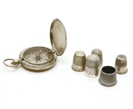A Wittnauer pocket compass, the silver plated case engraved 'U.S' to the front, together with a collection of thimbles