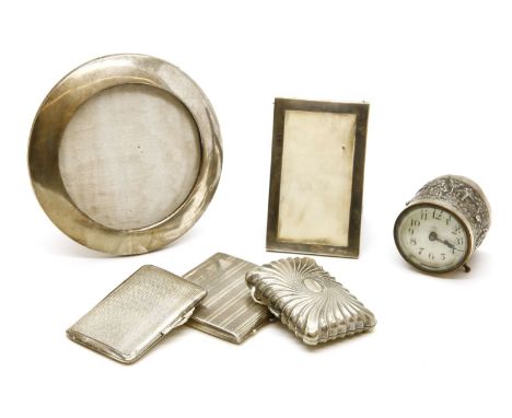A circular silver easel back photograph frame, an easel back and ivory mounted note panel, three cigarette cases, and an Indi
