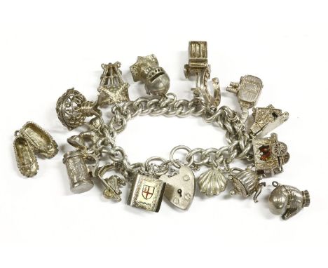 A silver charm bracelet with padlock, and a quantity of assorted silver charms including a lantern, shell, carriage, and two 