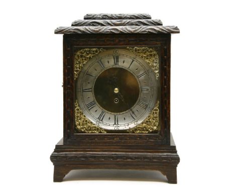 An oak cased bracket clock, the fusee movement with an anchor escapement from a longcase clock, with a silvered chapter ring,