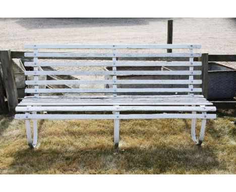 A 20th century railway style bench, the slatted wooden back and seat on a carved metal framework, 183cm wide