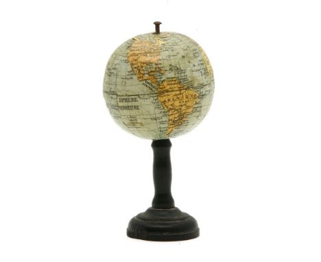 A French 5.5cm diameter Globe by L N K Editers, on an ebonised stand, 11.5cm high