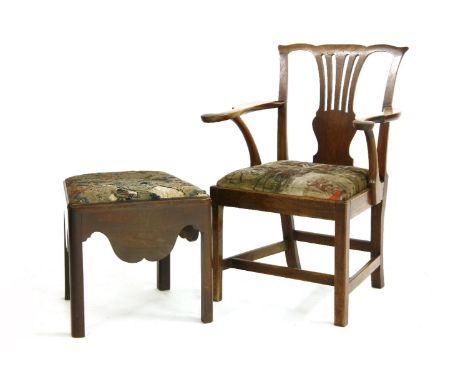 A George II mahogany commode stool, with shaped apron and needlework seat, together with a George III elbow chair, with pierc