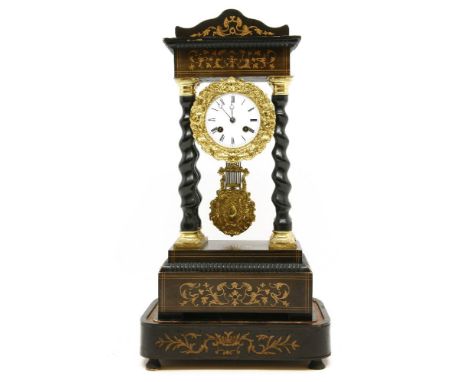 A 19th century French Portico clock, the white enamel dial having black Roman numerals, on turned column supports, under dome