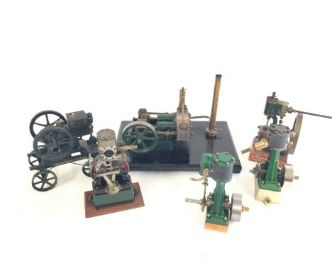 A small collection of live steam engine models plus a McCormack Deering toy cart.