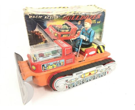 A boxed Vintage Battery Operated Magic Action Tin Bulldozer.