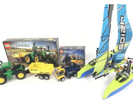 A Lego John Deere 9620R 4WD Tractor #42136 (With Box). A Dump Truck #42147 (With Box) and a Catamaran #42105. NO RESERVE