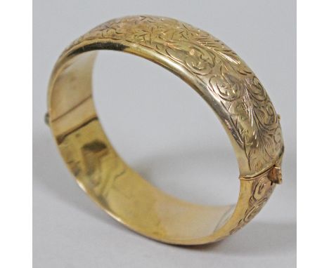 A hallmarked 9ct gold bangle, diam. approx. 6cm, wt. 25.9g.  Condition - lacking safety chain, general wear to include a numb
