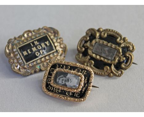 A group of three William IV/early Victorian yellow metal and black enamel mourning brooches.  