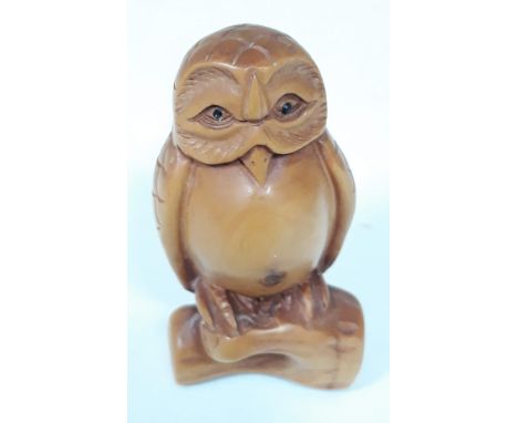 A Japanese carved hardwood Netsuke, length 6cm. 