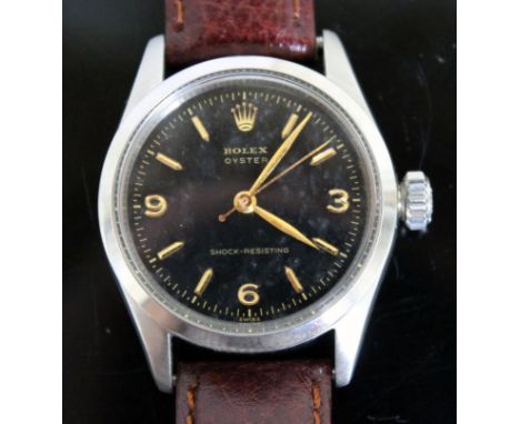 A vintage Rolex Oyster Shock-Resisting stainless steel wristwatch circa 1955, black dial with gold hands and numerals, diam. 