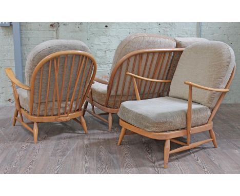 A Ercol light beech three piece suite.Condition: Some wear to arms on armchairs, one more worn than the other, arms ok on set