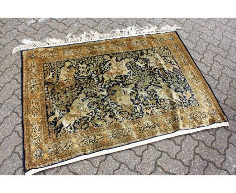 AN EASTERN PART SILK HANGING, the central panel decorated with a hunting scene with figures on horseback, the border with cal