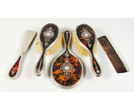 A SUPERB TORTOISESHELL AND PIQUE SILVER FIVE-PIECE DRESSING TABLE SET, hand mirror, comb, shoe horn and two brushes. London 1