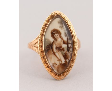 A GEORGIAN GOLD OVAL PORTRAIT RING, a young girl with a dog.