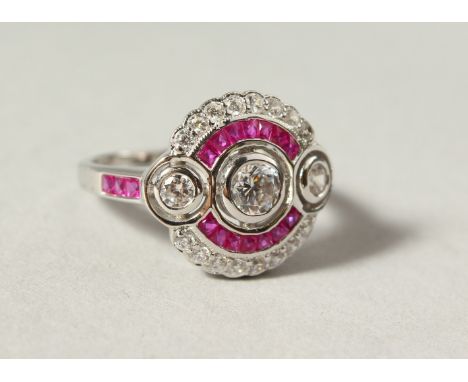 A SILVER PASTE AND RUBY CLUSTER RING.