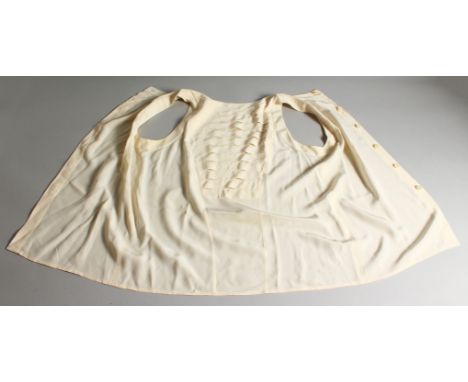 A CHANEL CREAM BLOUSE, in a Chanel bag.