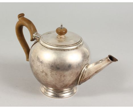 A GEORGIAN TEAPOT with wooden handle. London 1932.  Maker: B. &amp; F. Ltd.  Weight 22ozs.
