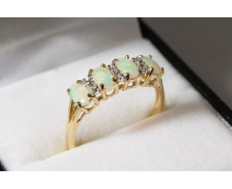 A 9CT GOLD FOUR-STONE OPAL AND DIAMOND RING.