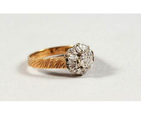 AN 18CT GOLD DIAMOND CLUSTER RING.