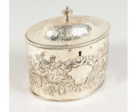 A GEORGE III OVAL TEA CADDY, the cover with urn finial and allover embossed decoration. London 1786.  5.5ins wide.