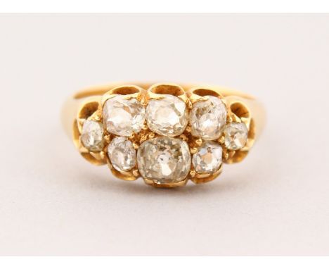 AN 18CT GOLD EIGHT STONE DIAMOND CLUSTER RING.