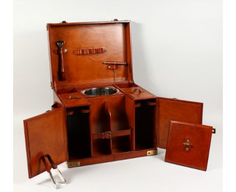 A LEATHER PICNIC HAMPER, with fitted interior. 17.5ins wide.