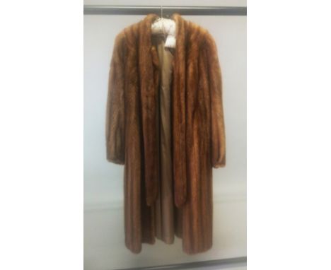 A LIGHT THREE QUARTER LENGTH FUR COAT.