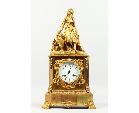 A 19TH CENTURY FRENCH ORMOLU MANTLE CLOCK, with eight-day movement, white dial surmounted by a young lady with a pitcher. 1ft