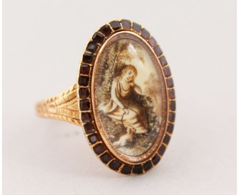 A GEORGIAN OVAL, GOLD AND RUBY SET RING, portrait of a young girl with a dog.