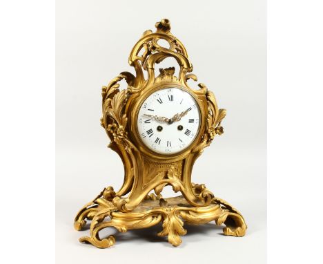 A GOOD FRENCH ROCOCO ORMOLU CLOCK, eight-day movement, striking on a bell, with circular enamel dial and Roman numerals. 17in