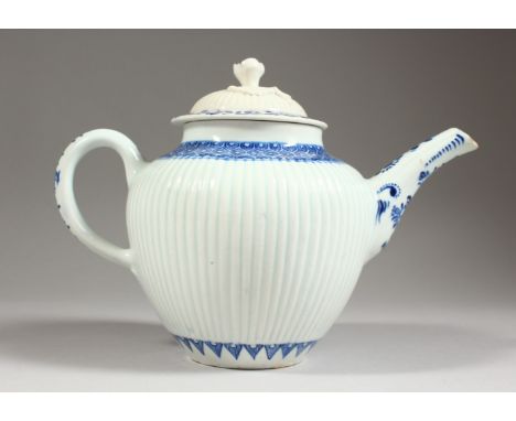 AN 18TH CENTURY ENGLISH PORCELAIN TEAPOT AND COVER, painted with flowers and cell borders in blue under-glaze, old paper labe