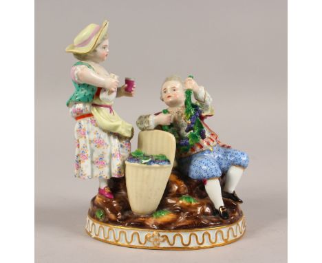 A GOOD MEISSEN GROUP OF A YOUNG BOY AND GIRL with hopper and fruiting vines. Cross swords mark in blue.  Incised F192.  6ins 