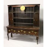 AN 18TH CENTURY OAK DRESSER, the upper section with three shelves and two cupboard doors, fitted