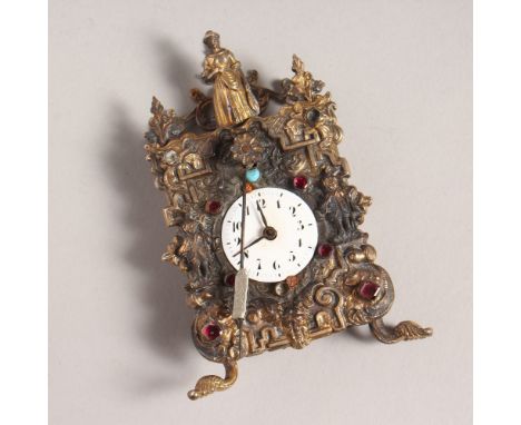 A MINIATURE CONTINENTAL SILVER CLOCK, with white enamel dial, figures and semi-precious stones. 4ins high.